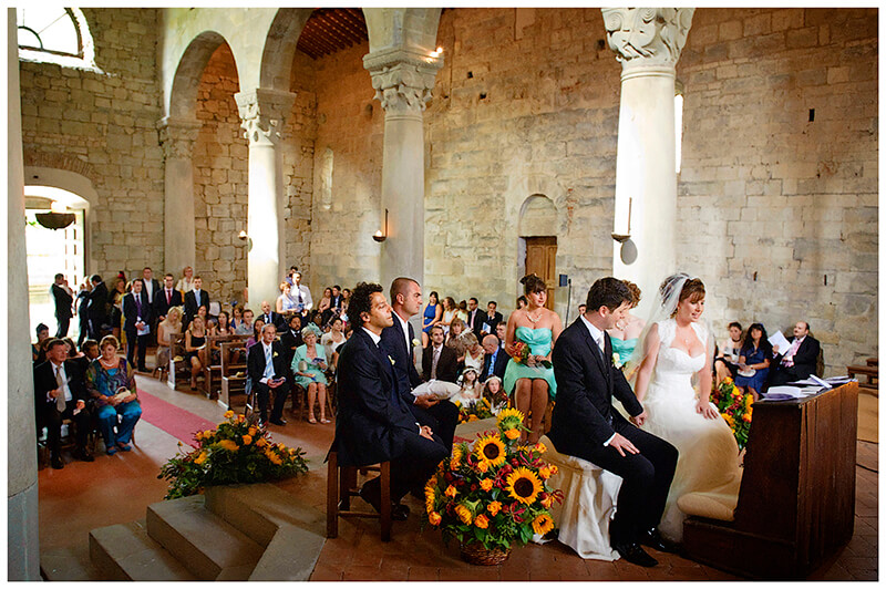 Fraternita di Romena Church Tuscany Wedding Photography bride groom looks at bride holding hands
