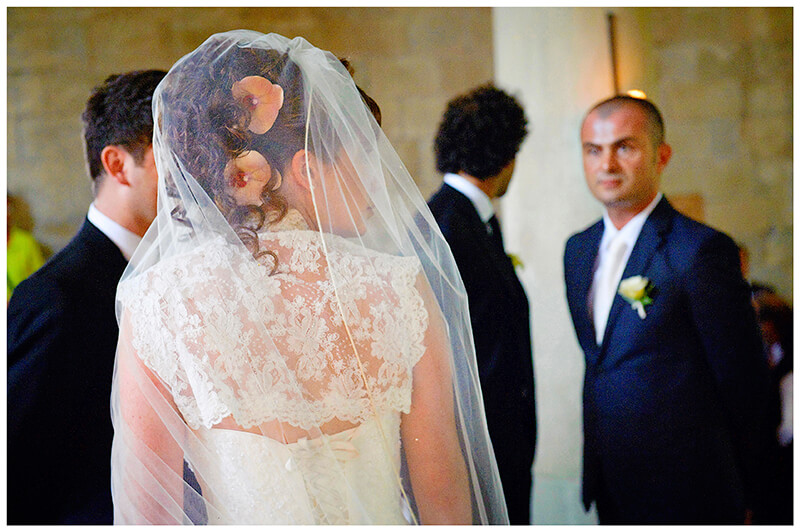 Fraternita di Romena Tuscany back of brides dress veil as she looks over shoulder