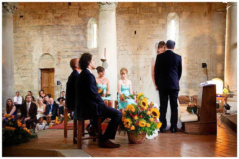Fraternita di Romena Tuscany guests watch as bride groom whisper to each other