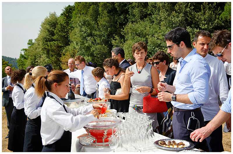 Wedding guests queuing for drinks at Castel di Poggio Tuscany 
