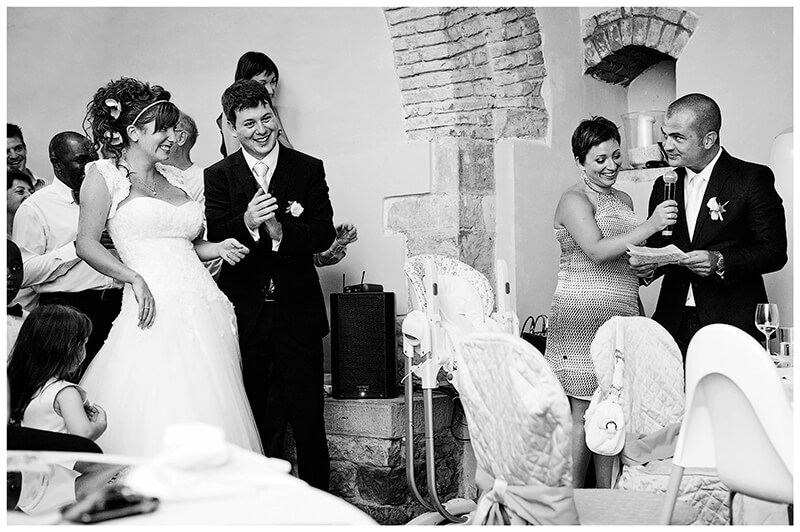 bride groom laughing at bestmans speech Castel di Poggio Tuscany Wedding venue