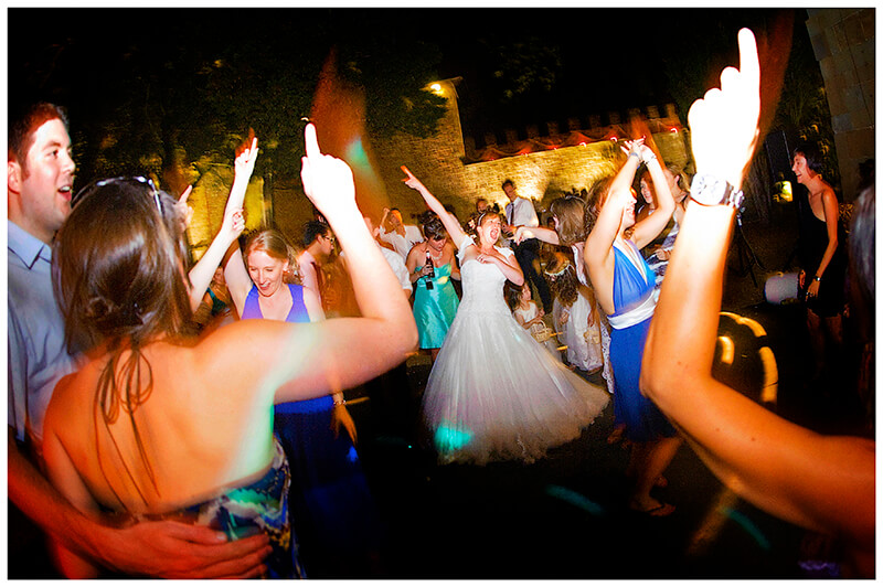 Bride on the centre of the outside dance floor surrounded by guests 