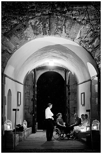 guests talking in archway Castel di Poggio Tuscany 