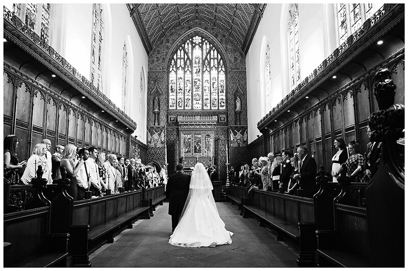 Bride and Father walking down the aisle of Queens College chapel