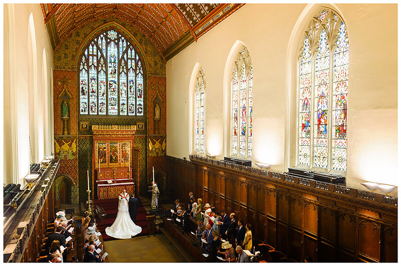 View from balcony of wedding inside Queens College chapel Cambridge