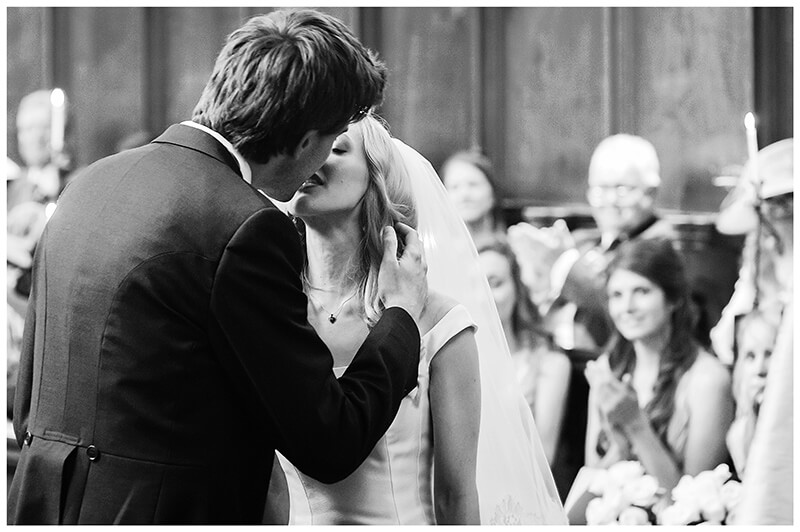 B ride groom kiss during Queens College wedding ceremony