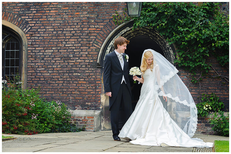 Queens College wedding Cambridge bride playing with veil