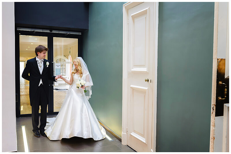 bride groom holding hands in corridor prior to entering dining room