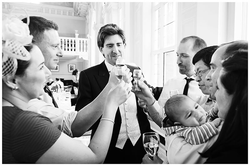 groom and friends about to have a drink toast