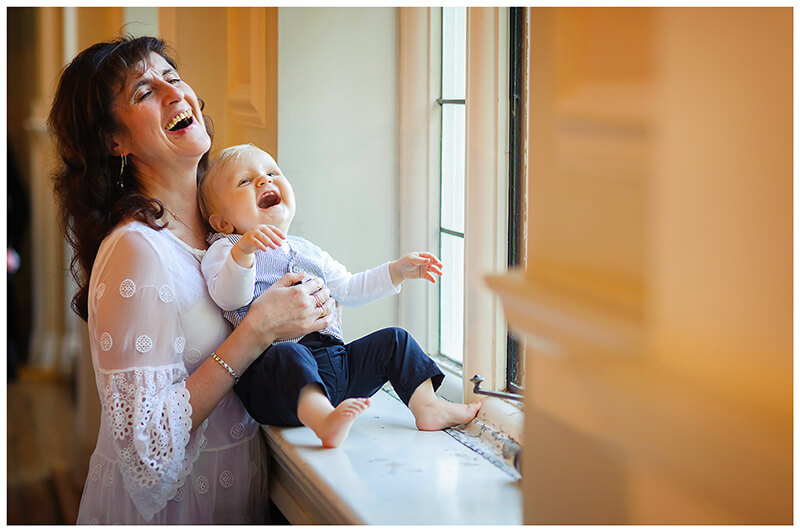 baby and lady laughing in window bay