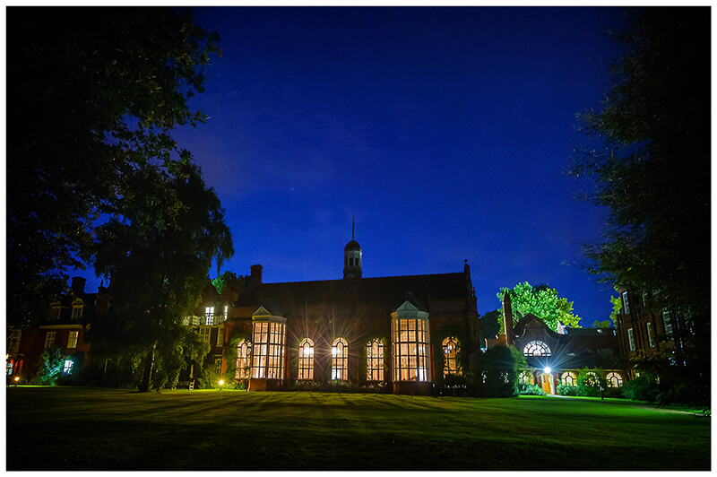 Newnham College Cambridge wedding venue under a dark blue night sky