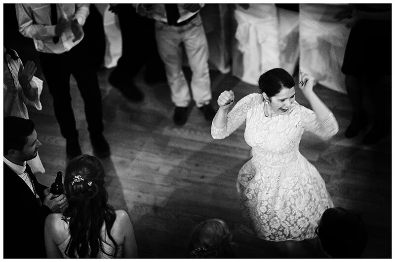 lady energetically dancing Newnham College Cambridge wedding reception