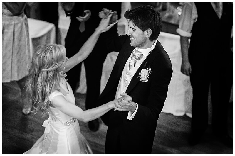 bride groom energetically dancing Nenham College wedding reception cambridge