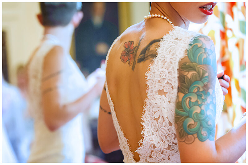 bride dress detail and colourful tattoo