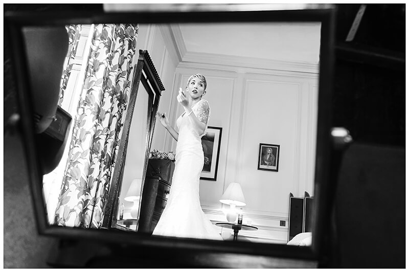 bride in dress reflected in mirror during bride preparations
