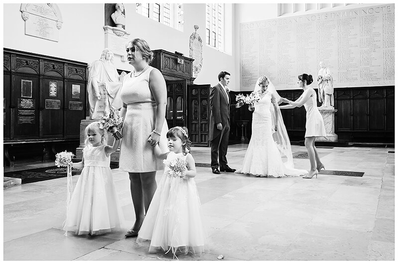 bridal party waiting to enter Trinity College chapel