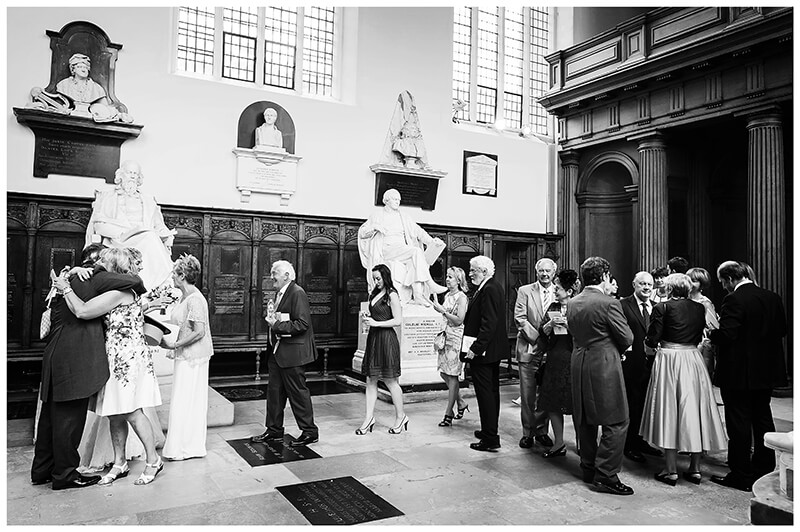 guests approach bride groom to congratulate them after ceremony at Trinity College wedding
