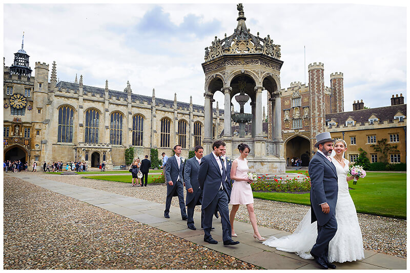 bridal party walking across Trinity College College Quad