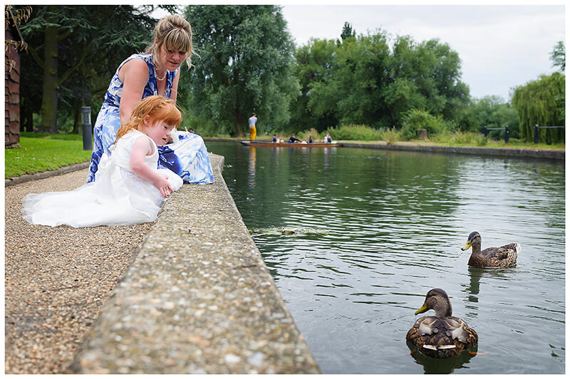 flower girl and mother near waters edge watching ducks at Cambridge Doubletree by Hilton Hotel Wedding 