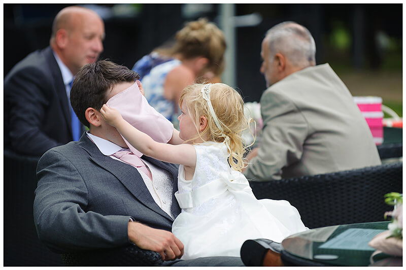 flower girl covers guys face with handkerchief