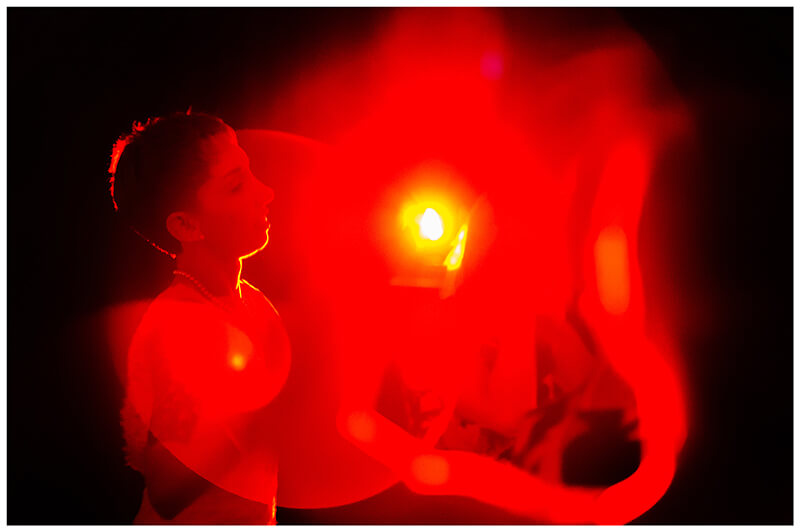 Bride in red light on dance floor