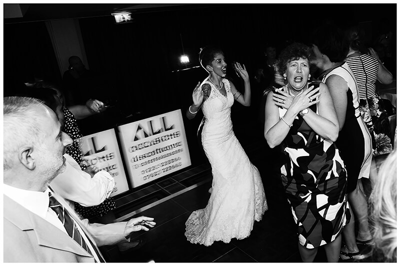 Wedding lady throwing shapes and pulling faces on dance floor