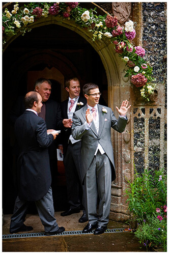 hengrave hall wedding groom waving to arriving guests