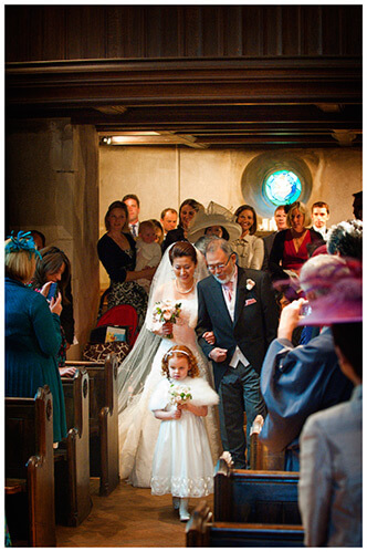 hengrave hall wedding flower girl walking down aisle in front of bride and father