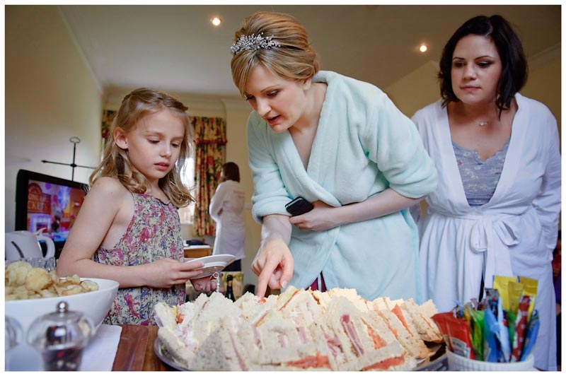 bride and bridesmaids choosing a sandwich during getting ready