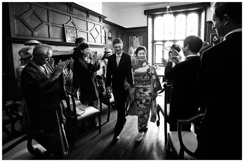 Japanese bride and her groom leaving the ceremony room