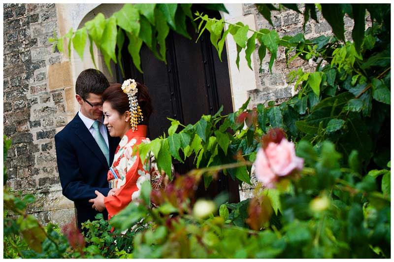 bride groom embrace amoungst roses