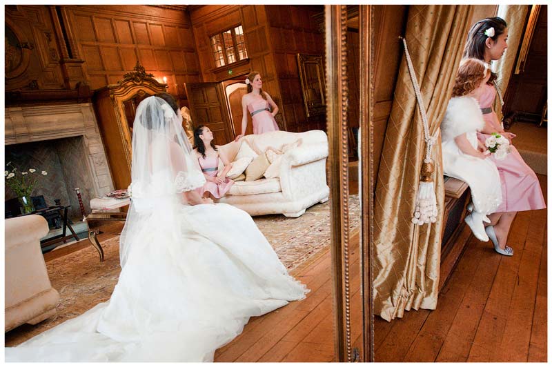 bride reflected in mirror talking to brides maids