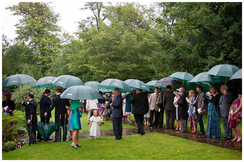 wedding guests standing in the rain