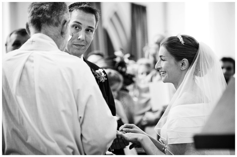 exchange wedding bands groom looks at vicar