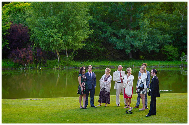 guests standing near lake 