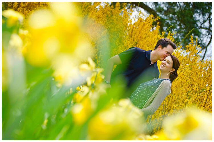 Fanhams Hall pre-wedding couple kiss, yellow blossom