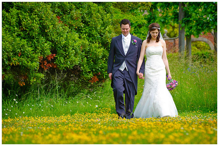 Fanhams Hall wedding bride groom romantic walk through yellow flowers