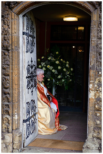 Higham Ferriers wedding vicar sat in doorway