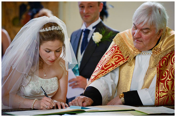 Higham Ferriers wedding bride signing the register