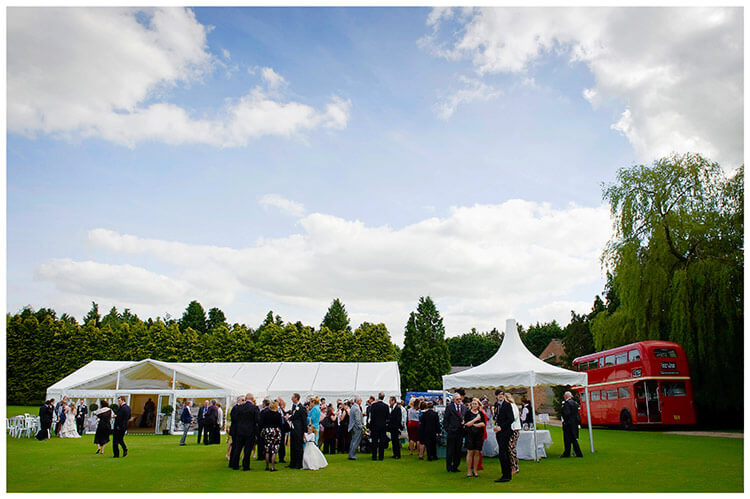Snelson Farm wedding marquee, red double decker bus, guests
