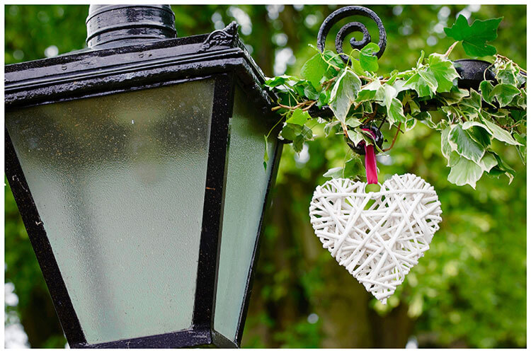 Leicestershire Kirby Muxloe wedding white wicker heart hanging next to lamp