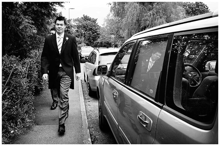 Leicestershire Kirby Muxloe wedding groom walking reflected in car window