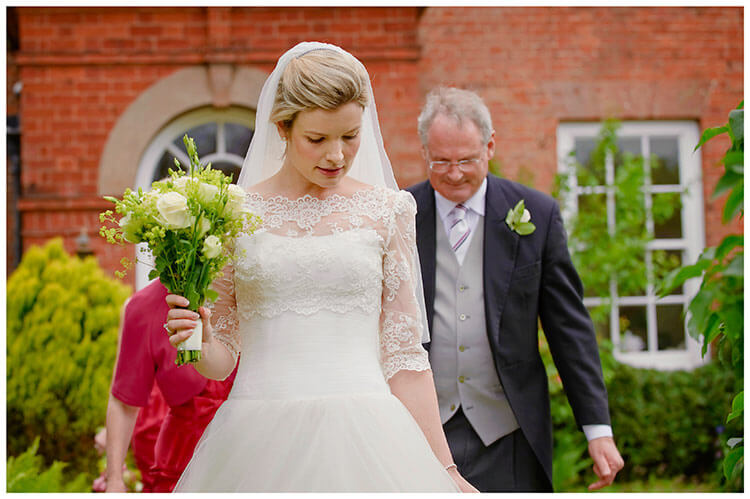 Leicestershire Kirby Muxloe wedding bride holding bouquet followed by father