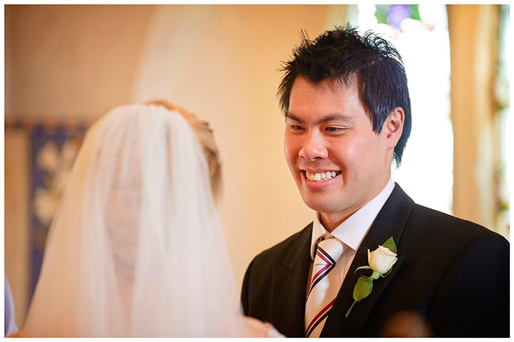 Leicestershire Kirby Muxloe wedding smiling groom looks at his bride to be