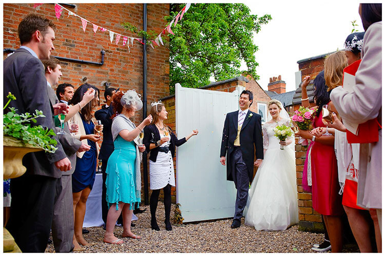 Leicestershire Kirby Muxloe wedding start of confetti throwing as bride groom enter