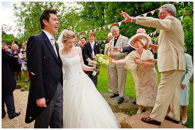 Leicestershire Kirby Muxloe wedding confetti thrown at bride groom smiling