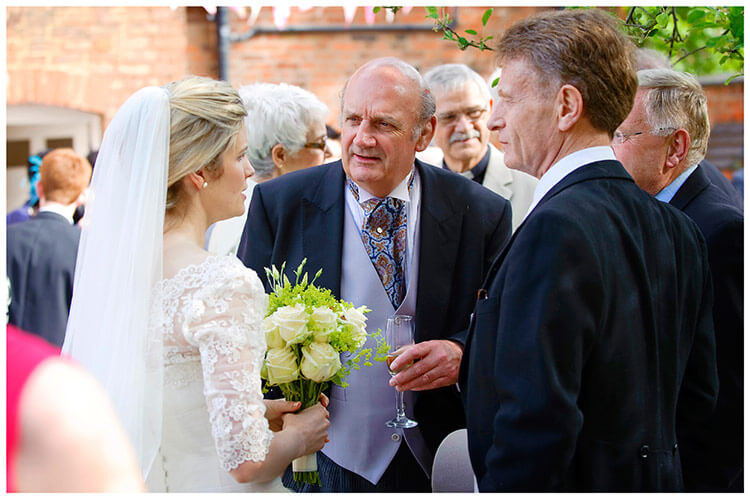 Leicestershire Kirby Muxloe wedding bride talking to gentlemen