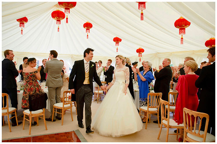 Leicestershire Kirby Muxloe wedding smiling bride groom walk into marquee to rapturous applause