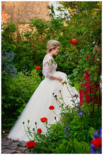 Leicestershire Kirby Muxloe wedding bride walking in garden holding dress