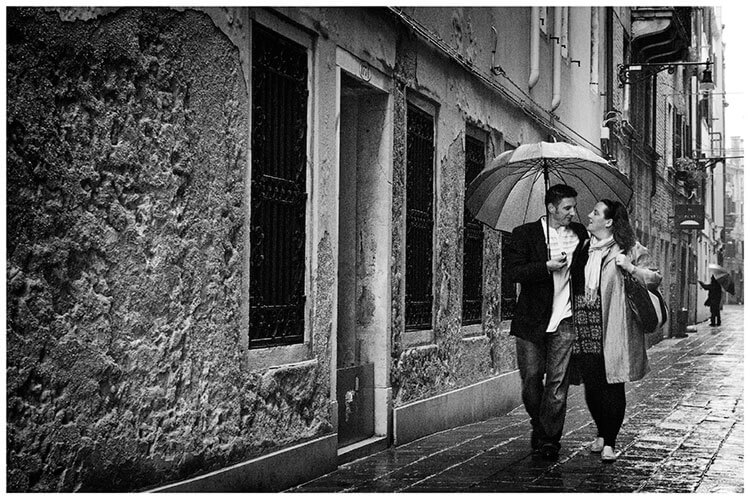 Venice Post Wedding Shoot photography couple holding umbrella walk streets of venice